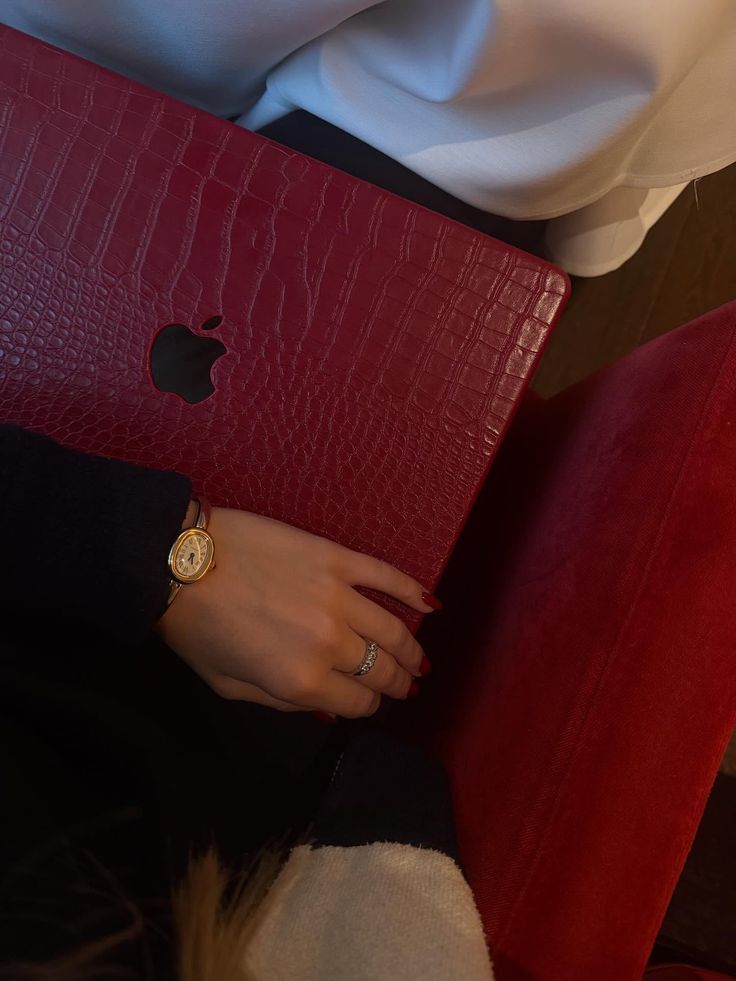 A burgundy leather laptop case held on a Resident's lap