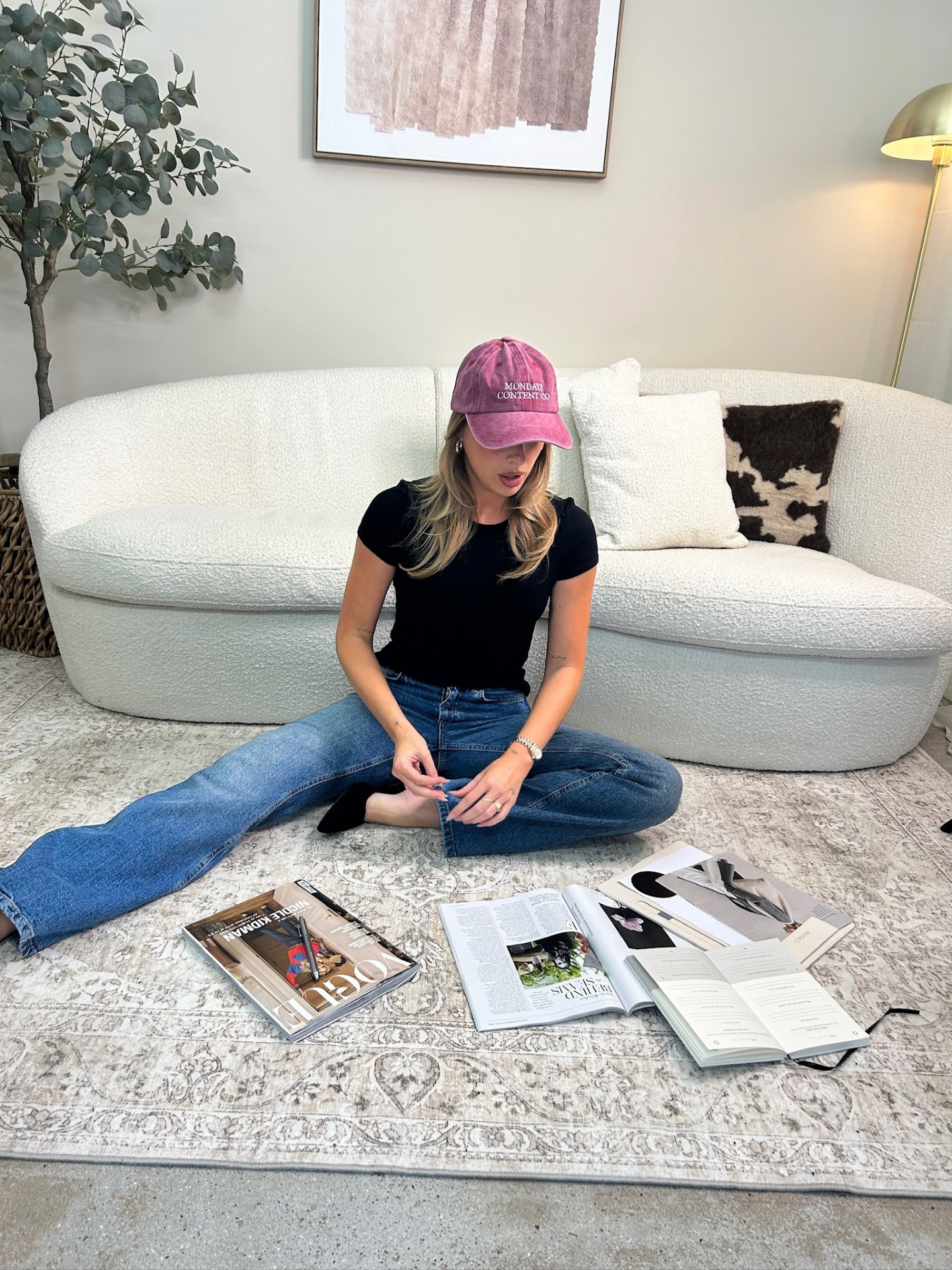 Sitting on the rug surrounded by magazines