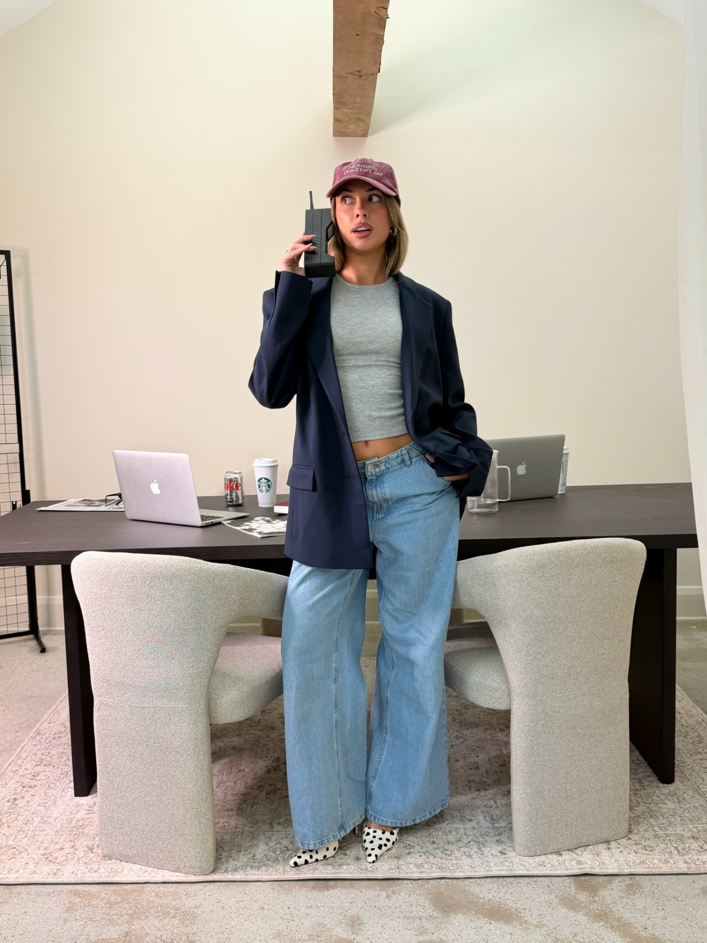 On the phone at the Mondays Content Co boardroom table